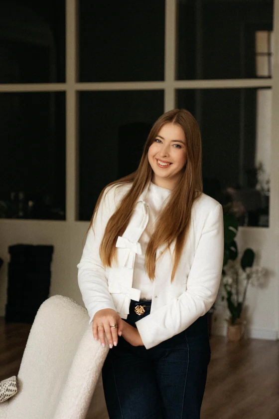 Aleksandra Stec opierająca się o fotel